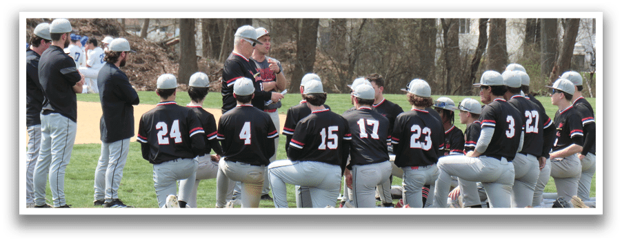 Baseball players wearing black jerseys and red helmets. Description generated by AI