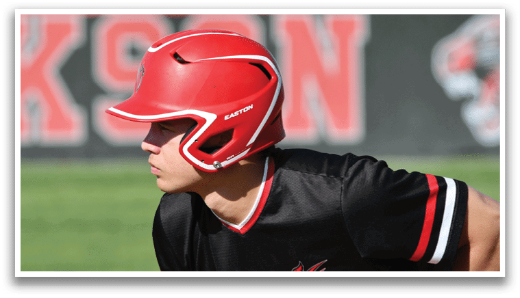 A baseball player in a black and red shirt is swinging a bat. Description generated by AI