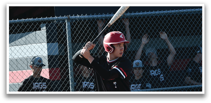A baseball player in a black and red uniform is holding a bat and waiting for the pitch. Description generated by AI