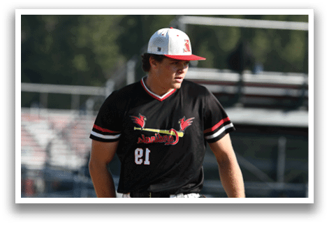 A baseball player wearing a black shirt with a red bird on it. Description generated by AI