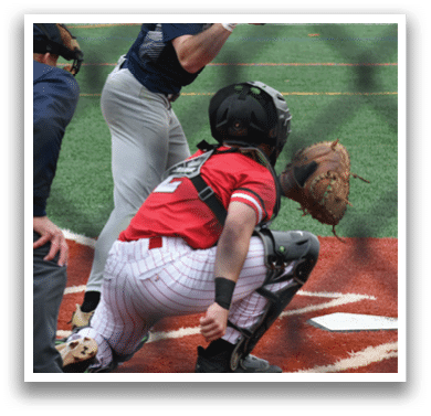 A baseball player holding a bat. Description generated by AI