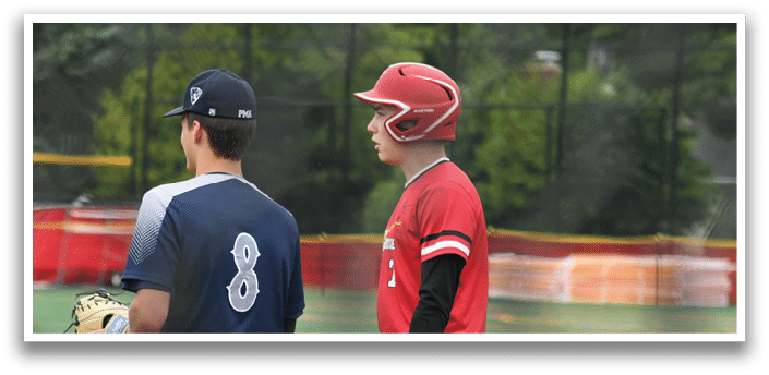 Two baseball players standing on a field. Description generated by AI