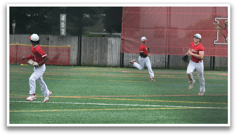 A baseball player in a black and red shirt is swinging a bat. Description generated by AI