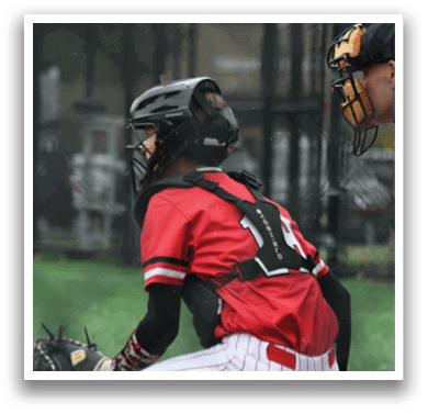 A baseball player wearing a helmet and kneeling down. Description generated by AI