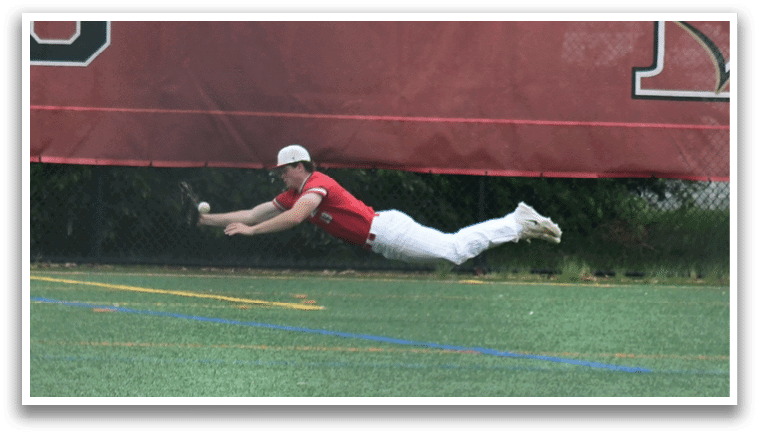 A baseball player diving for a ball. Description generated by AI