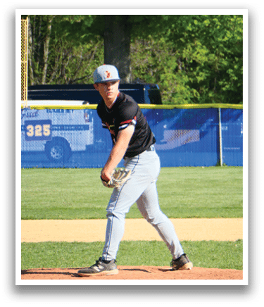 A baseball player in a black shirt and grey pants is pitching a ball. Description generated by AI
