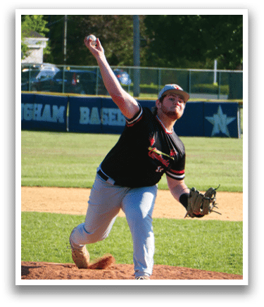 A man in a black shirt and white pants is throwing a baseball. Description generated by AI