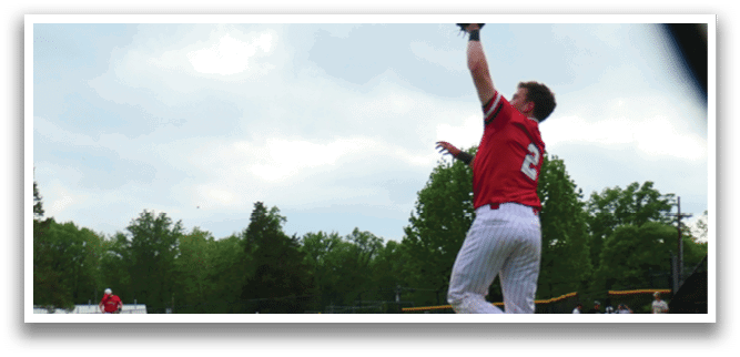A baseball player catching a ball. Description generated by AI