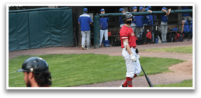A baseball player holding a bat. Description generated by AI