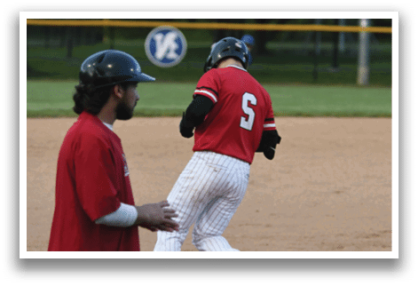 A baseball player wearing a red shirt with the number 2 on it. Description generated by AI