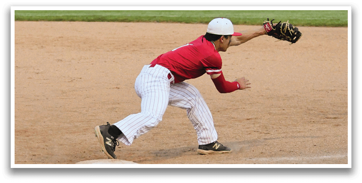 A baseball player in a red shirt and white hat is catching a ball. Description generated by AI