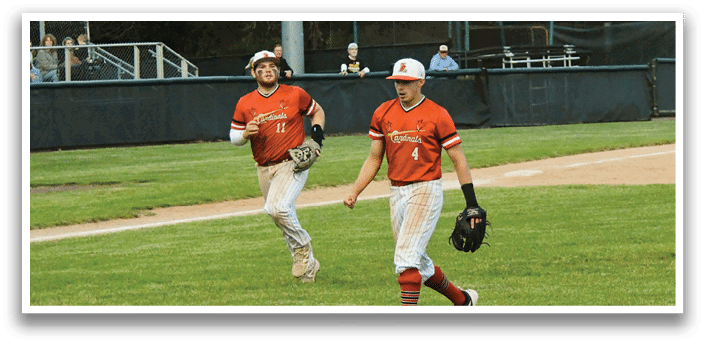 A baseball player wearing a red shirt and white pants is walking on the field. Description generated by AI