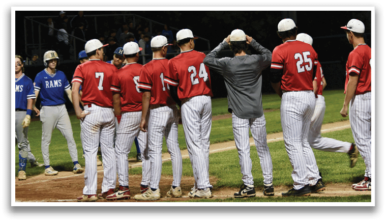 A group of baseball players standing on a field. Description generated by AI