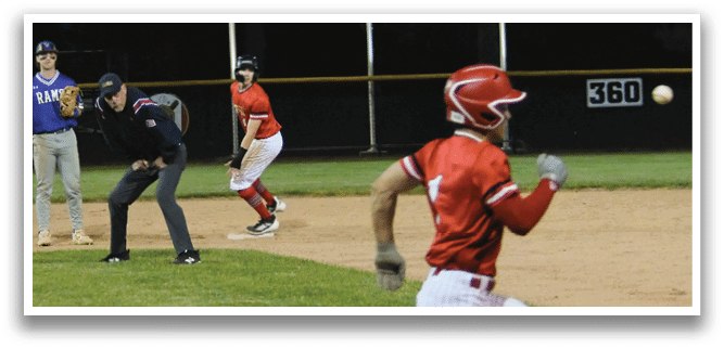 A baseball player running to a base. Description generated by AI