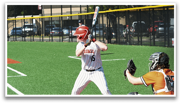 A baseball player is holding a bat and getting ready to hit the ball. Description generated by AI