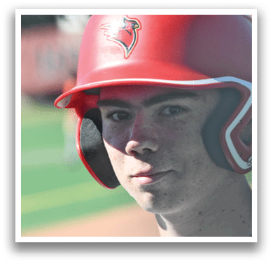 A boy wearing a red helmet. Description generated by AI