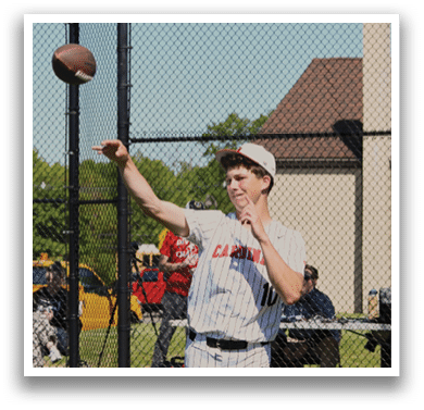 A man catching a football. Description generated by AI