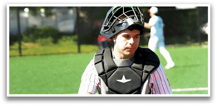 A baseball player wearing a black and white uniform and a catcher's mitt. Description generated by AI