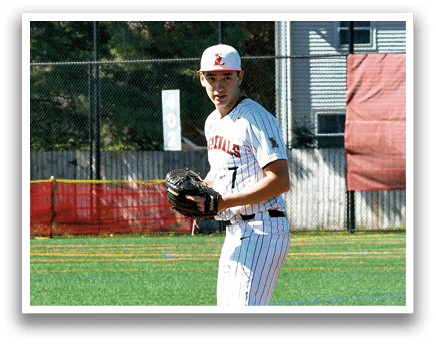 A baseball player in a red and white uniform stands on a pitcher's mound. Description generated by AI