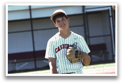 A baseball player wearing a white and red striped uniform and a baseball glove. Description generated by AI