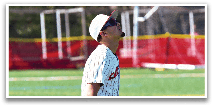 A baseball player wearing a white and black uniform. Description generated by AI
