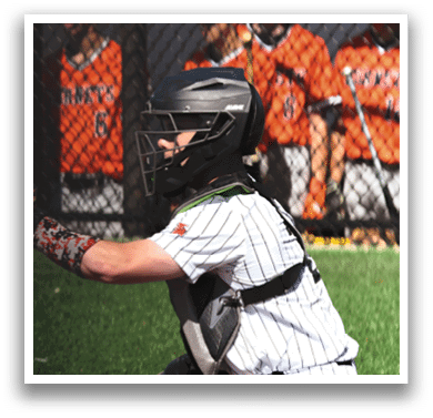 A baseball player wearing a helmet and catcher's gear. Description generated by AI
