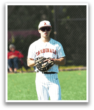 A baseball player wearing a red shirt and white pants. Description generated by AI