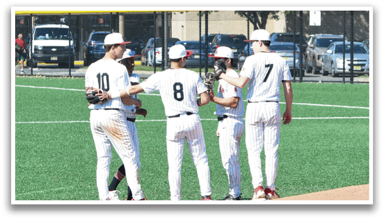 A group of baseball players standing on a field. Description generated by AI