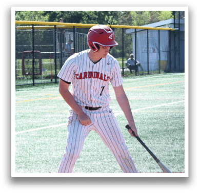 A baseball player in a red helmet and white uniform holding a bat. Description generated by AI