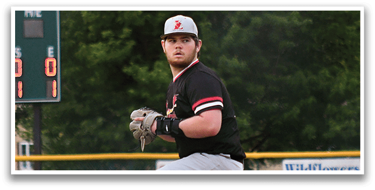 A baseball player wearing a black and red shirt and grey pants. Description generated by AI