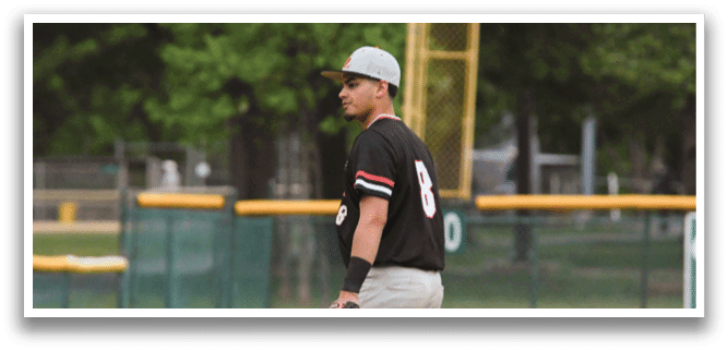 A baseball player wearing a black shirt and grey pants. Description generated by AI