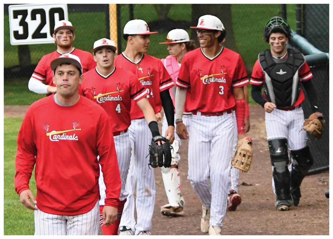 A group of baseball players walking on a field. Description generated by AI