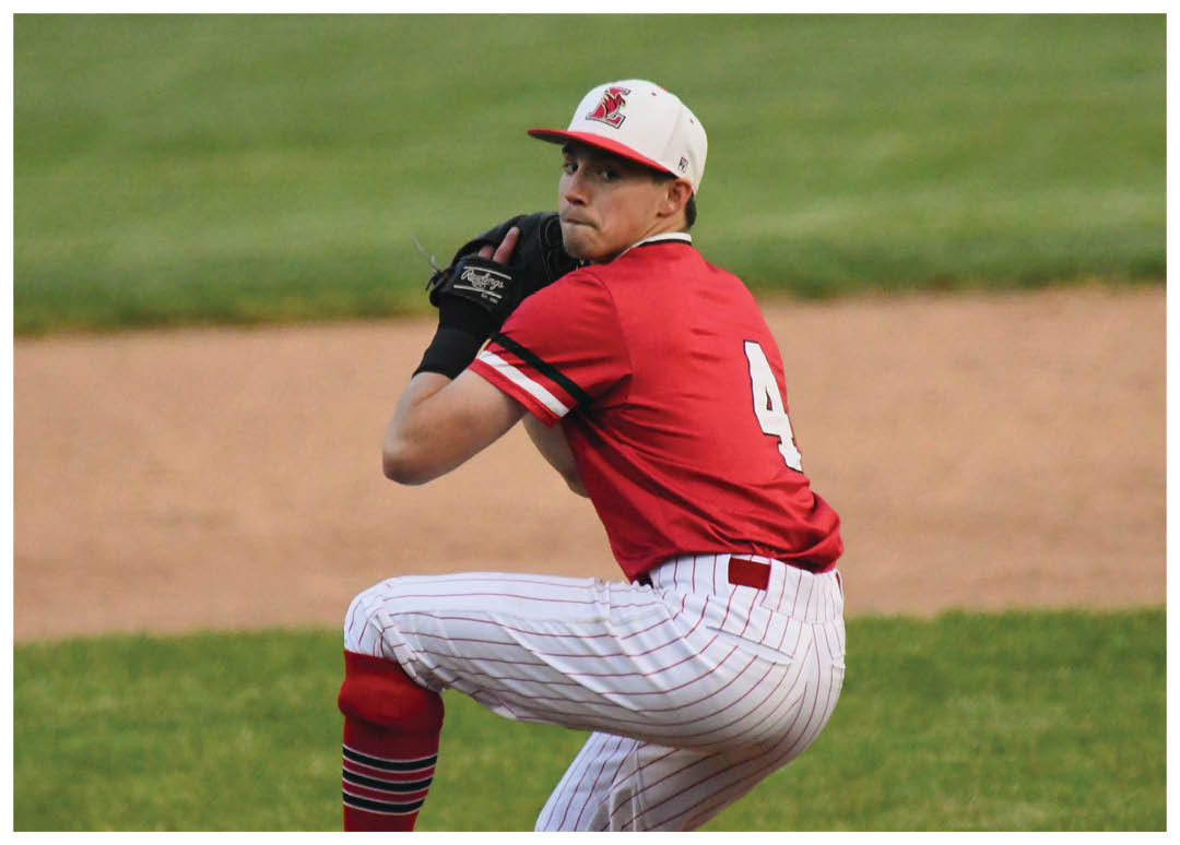 A baseball player in a red and white uniform is crouching on the field. Description generated by AI
