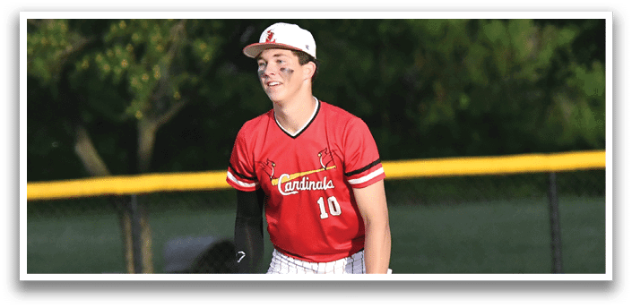 A baseball player wearing a red shirt and white pants. Description generated by AI