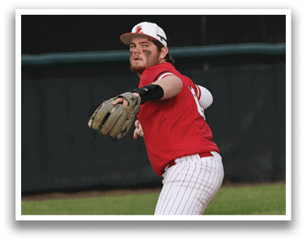 A baseball player in a red shirt and white pants is throwing a ball. Description generated by AI