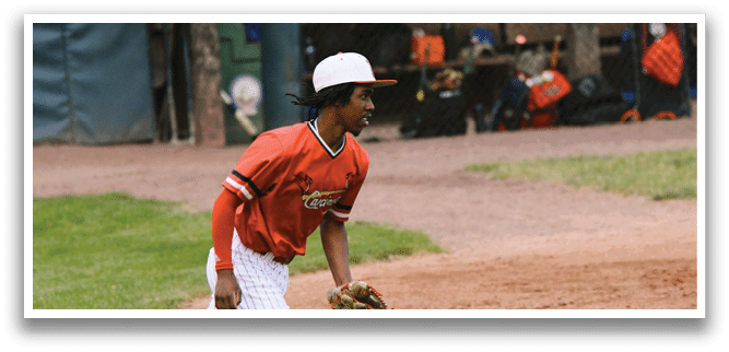 A baseball player wearing a red shirt and white pants. Description generated by AI