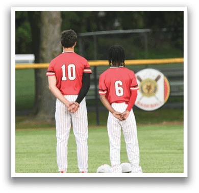 Two baseball players standing on a field. Description generated by AI