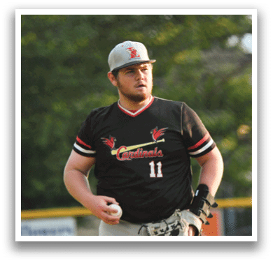 A baseball player wearing a black shirt with the number 14 on it. Description generated by AI