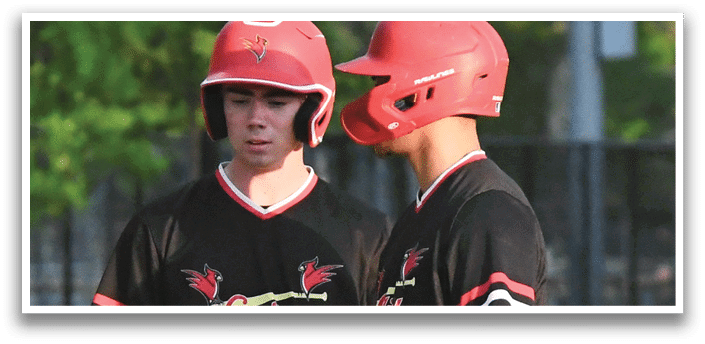 Two baseball players wearing red helmets and black shirts. Description generated by AI