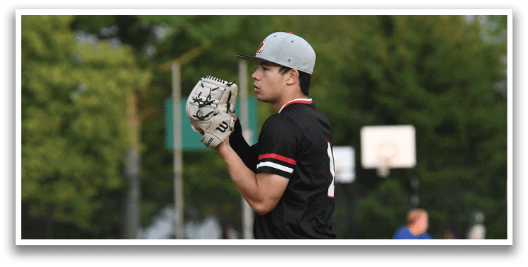 A baseball player wearing a black shirt and gray pants. Description generated by AI