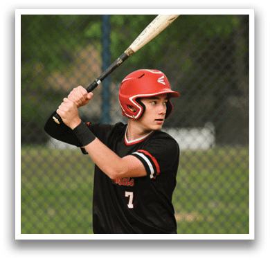 A baseball player in a black shirt and red helmet is swinging a bat. Description generated by AI