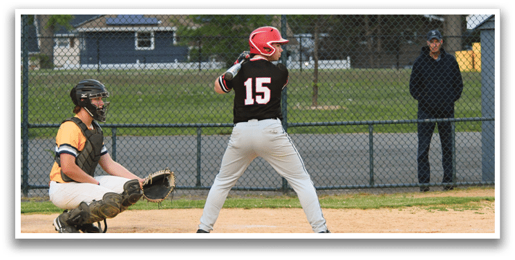 A baseball player is swinging a bat on a field. Description generated by AI