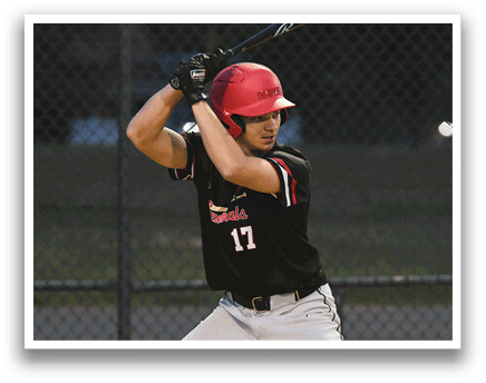 A baseball player in a black and red shirt is swinging a bat. Description generated by AI