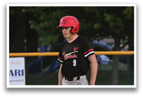A baseball player wearing a red helmet and black shirt. Description generated by AI