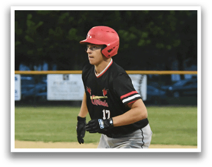 A baseball player in a yellow shirt and black and white striped hat. Description generated by AI