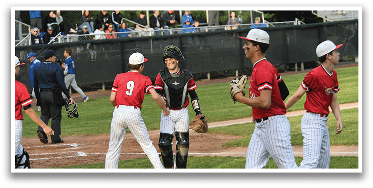 A group of baseball players on a field. Description generated by AI