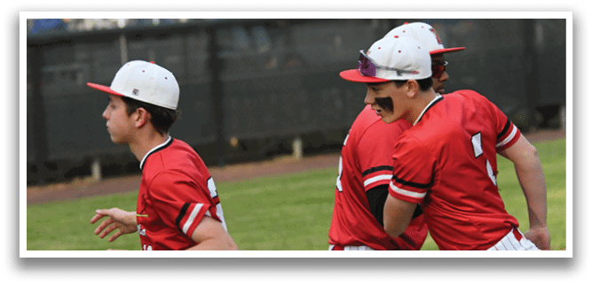A baseball player wearing a red shirt and white pants. Description generated by AI