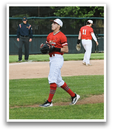 A baseball player wearing a red shirt and white pants. Description generated by AI