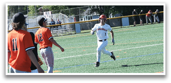 A baseball player wearing a red hat and white uniform is running towards a base. Description generated by AI