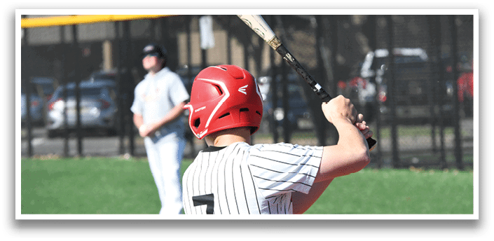 A baseball player in a red helmet is swinging a bat. Description generated by AI